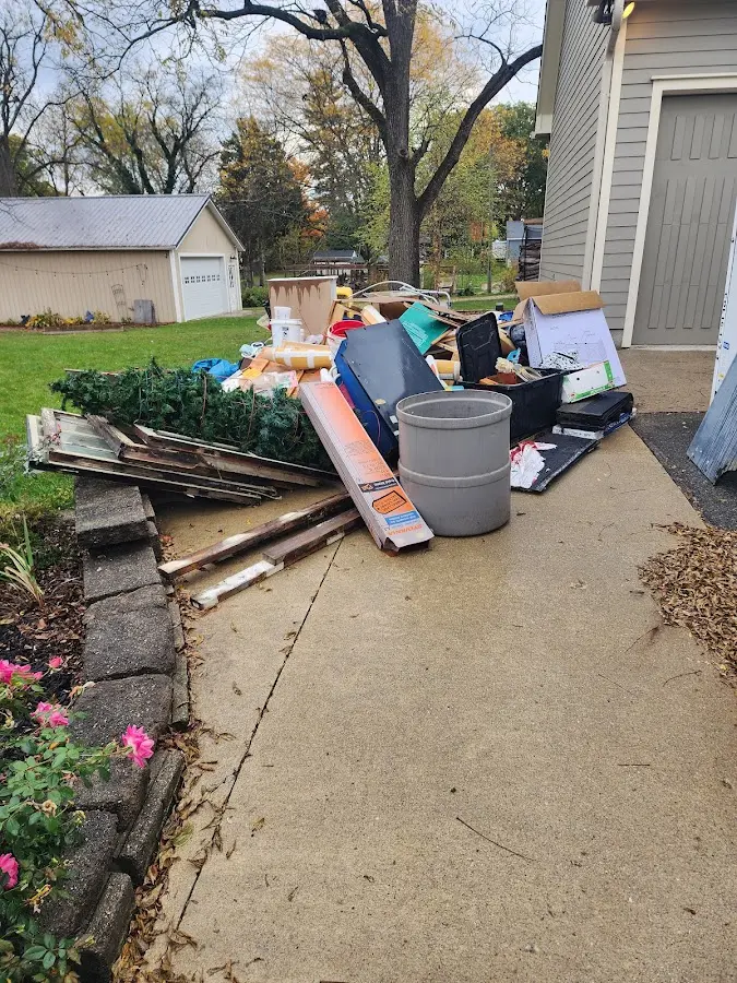 Dumpster being loaded with debris for 3 Yard Dumpster Rental in Bondurant